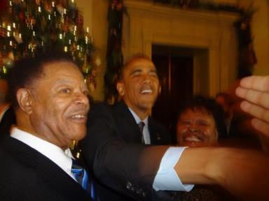 Richmond city councilmember Nat Bates, left, and his daughter, Gale pose with President Barack Obama during a meet-and-greet at a White House Christmas party on Dec. 17. (Photo courtesy of Nat Bates)